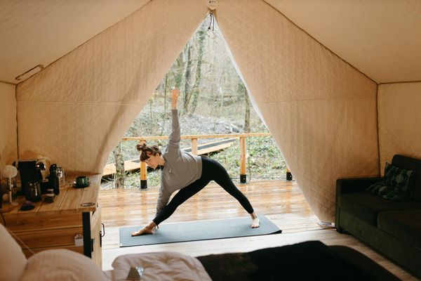 A person moving through a sequence of yoga poses in a calm environment.